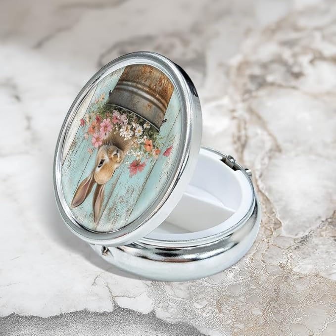Portable Round 3 Compartment Metal Pill Box Features a Bunny in a Bucket Filled with Flowers for Organizing Medications Travel Essentials and Gift Giving